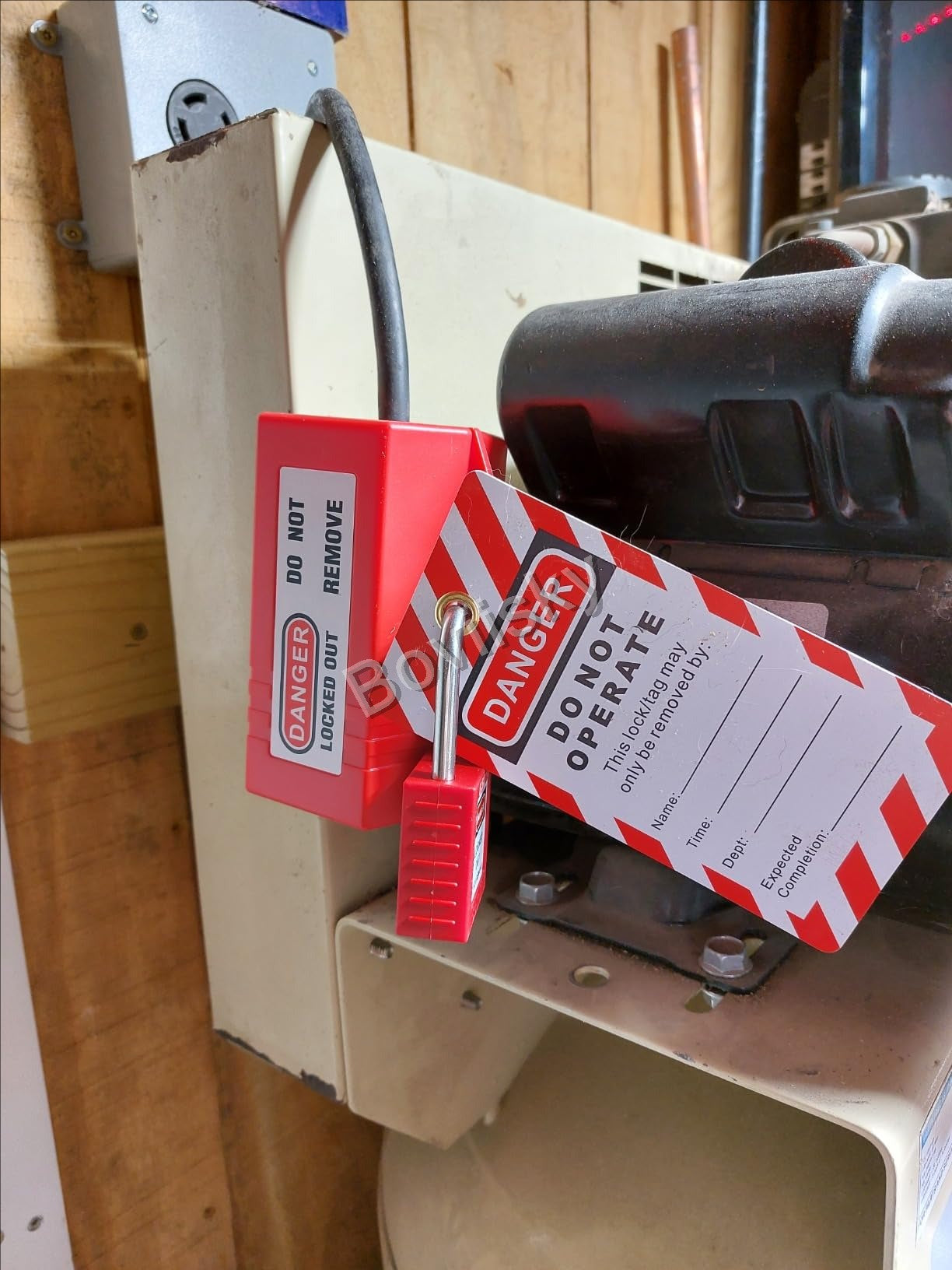 Plug lockout device secured with a padlock and danger tag