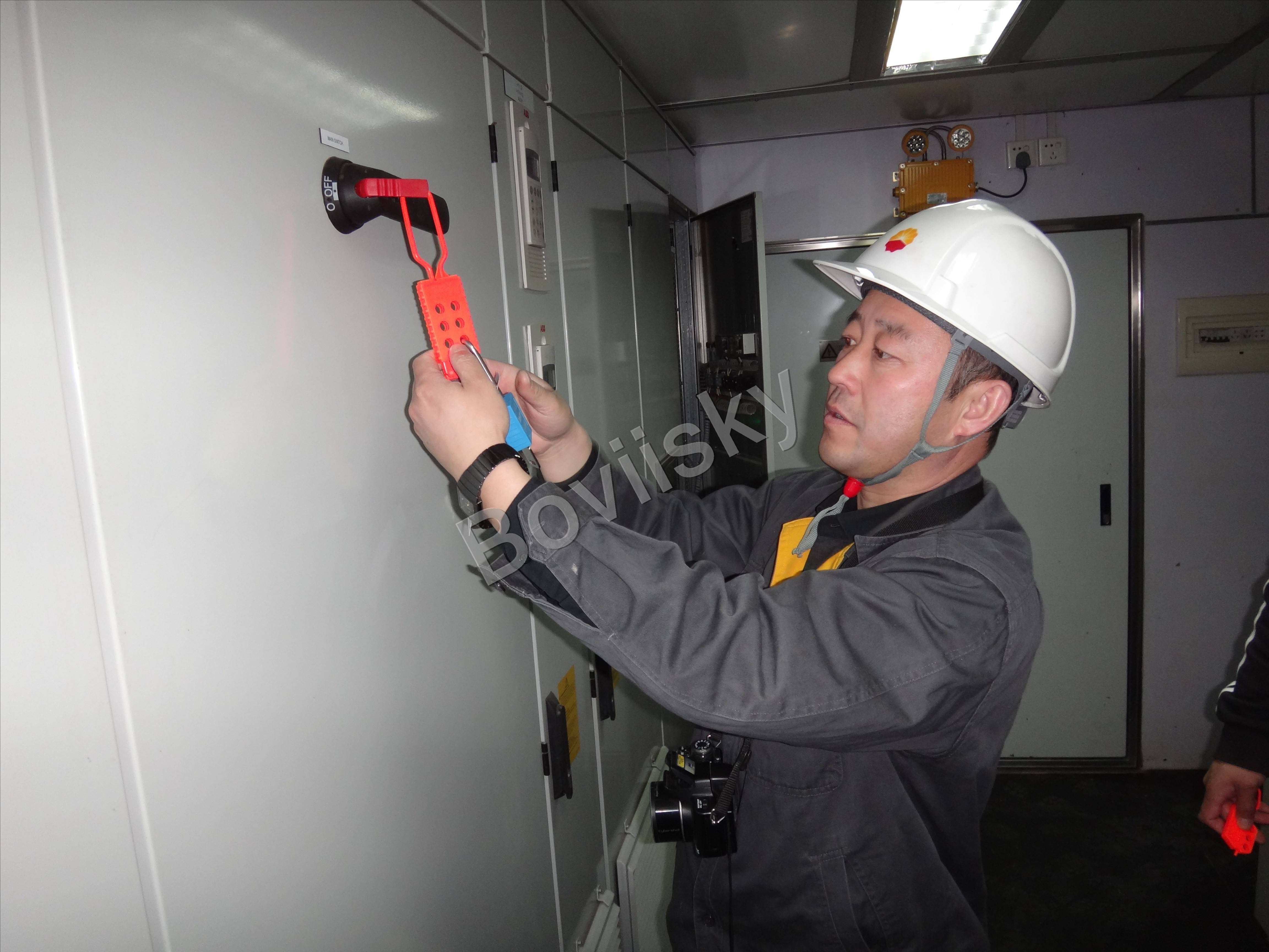 Worker applying an electrical lockout device