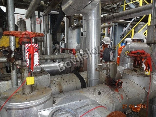 Lockout tagout devices applied across an industrial process area